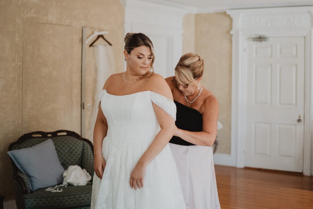 Discover Kirsten + Charlie’s romantic August wedding at Gwyn Careg Inn. Elegant details, lush florals, and timeless photography.