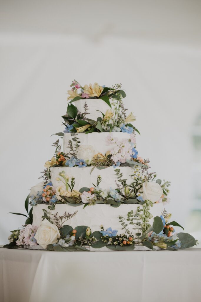 Discover Kirsten + Charlie’s romantic August wedding at Gwyn Careg Inn. Elegant details, lush florals, and timeless photography.